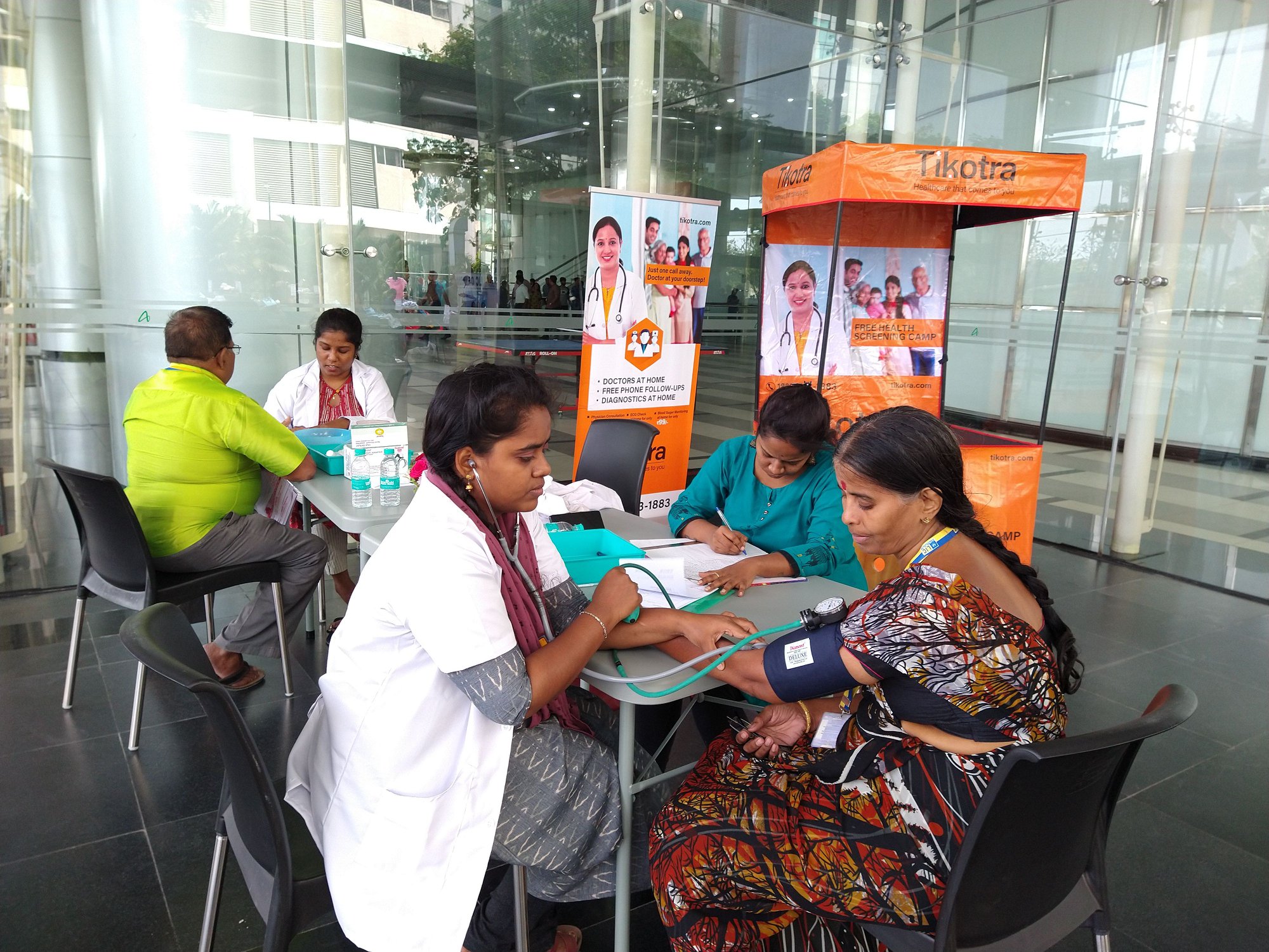 Tikotra's Nurse checking vitals at a corporate medical camp in Chennai